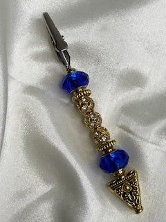 Gold-tone roach clip accented with royal blue crystals and sparkling rhinestone beads.