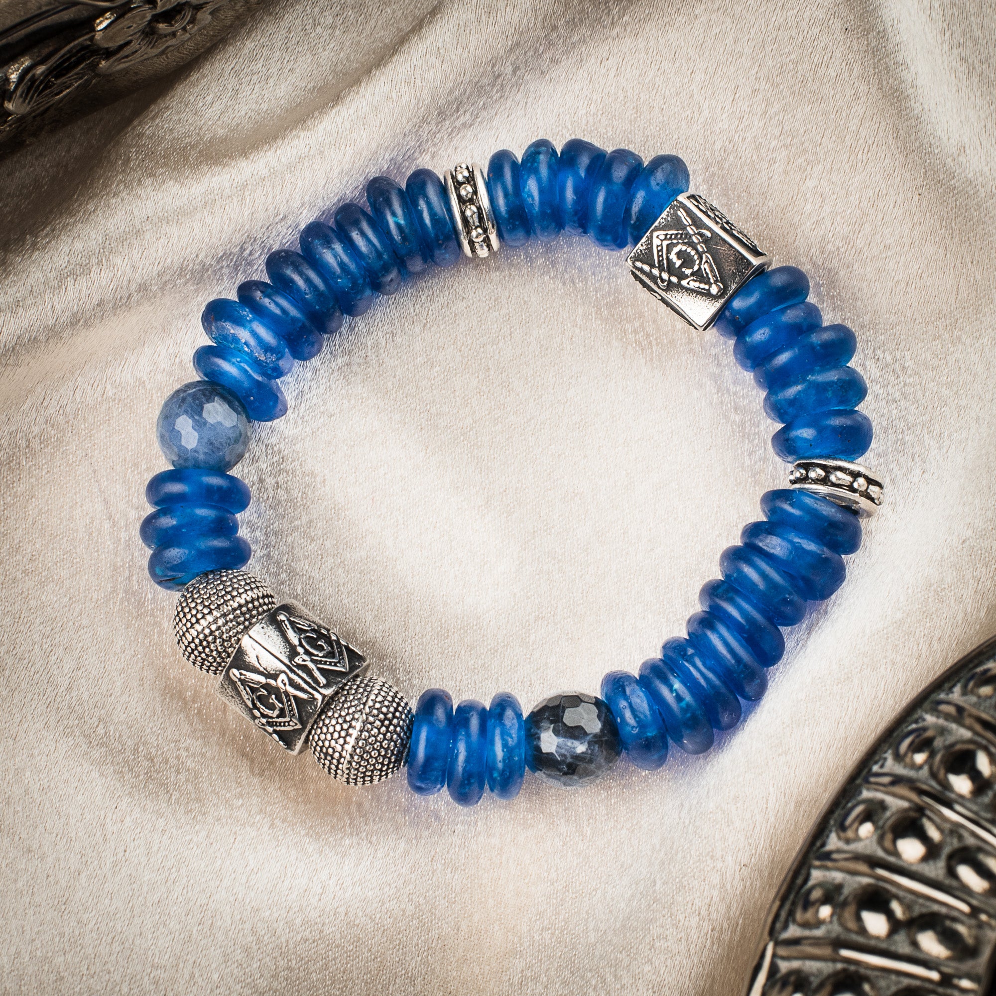 Blue beaded stretch bracelet featuring silver-tone Masonic Square and Compasses charms.