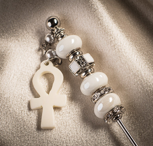 Elegant silver-tone cigar nubber with white decorative beads and a cream-colored Ankh symbol charm.